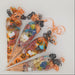 Halloween-themed candy cones with decorative ribbons on a white background
